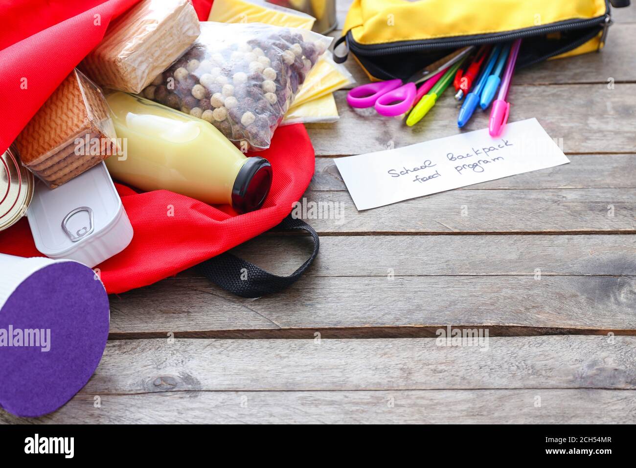Schoolbag with different products on table. Concept of Backpack Food ...