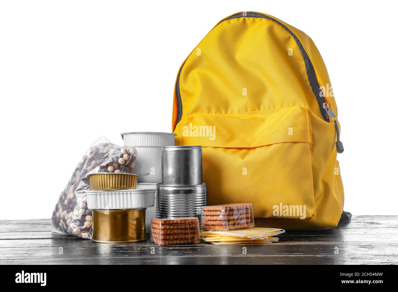 Schoolbag with different products on table against white background ...