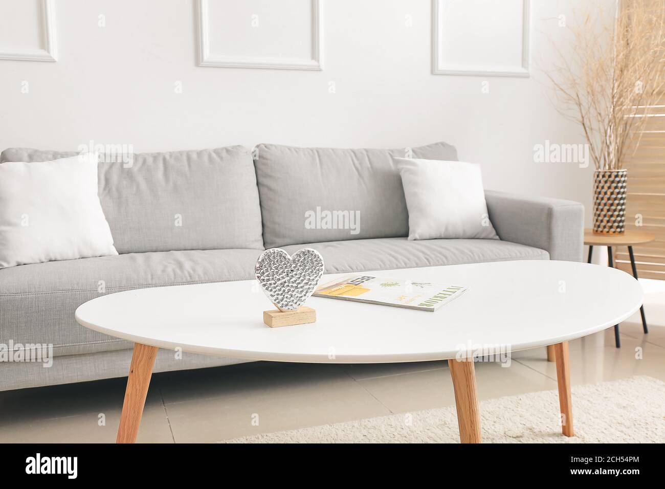 Stylish interior of living room with comfortable sofa and table Stock ...