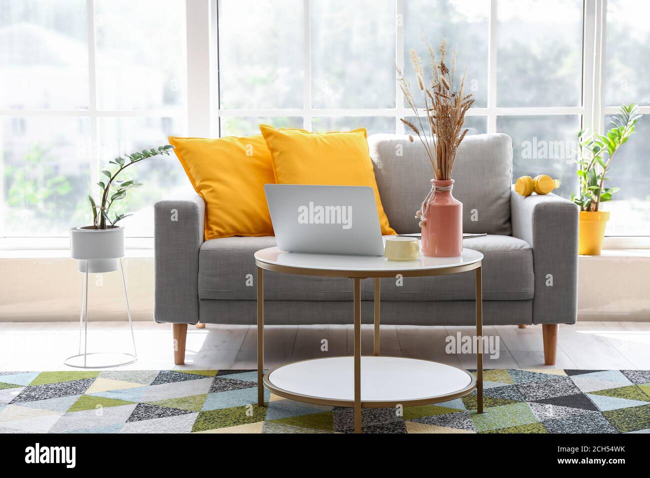 Stylish interior of living room with comfortable sofa and table Stock ...