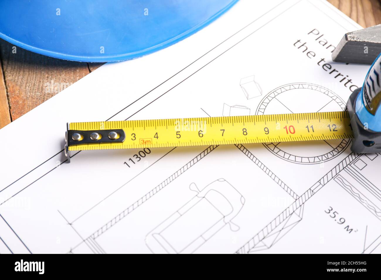 Measuring tape with blueprint on table Stock Photo Alamy