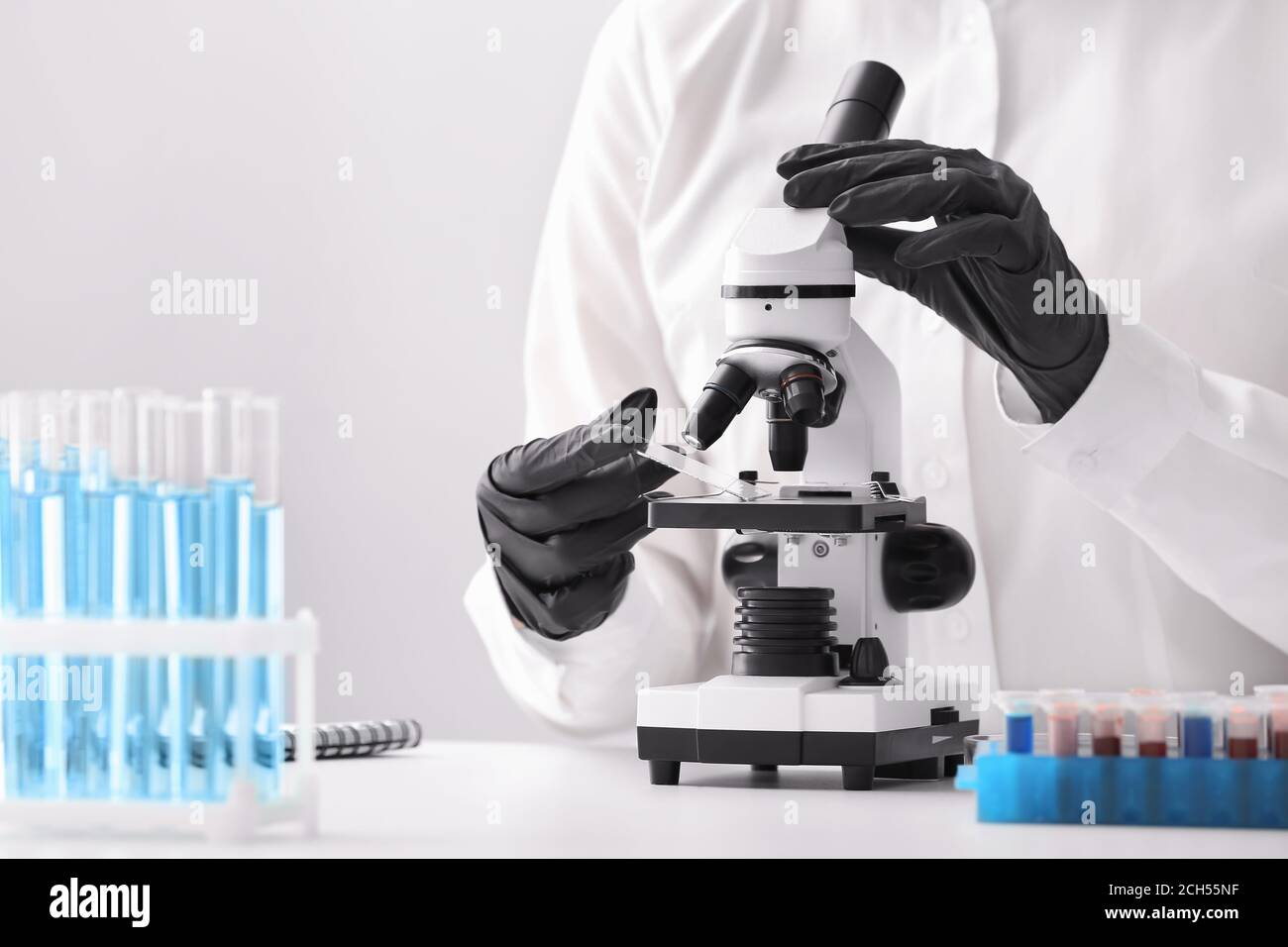 Scientist using microscope in laboratory Stock Photo - Alamy