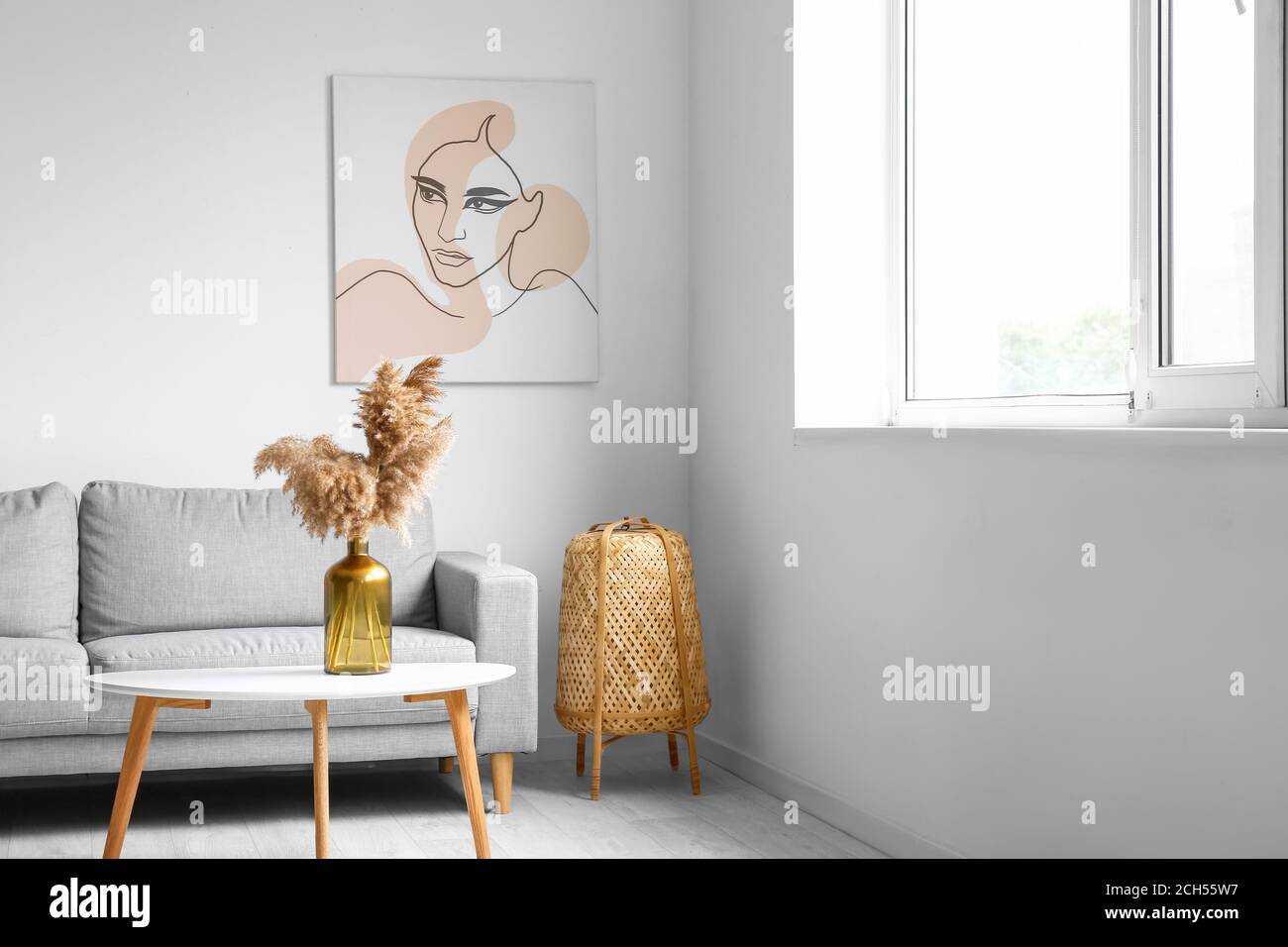 Stylish interior of living room with table and sofa Stock Photo - Alamy