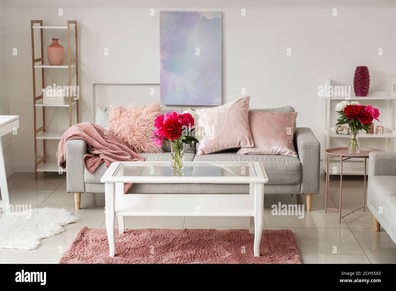 Stylish interior of living room with table and sofa Stock Photo - Alamy