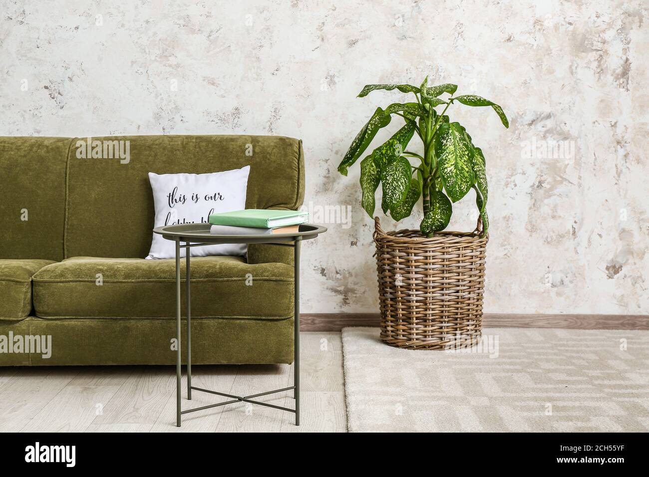 Stylish interior of living room with table and sofa Stock Photo - Alamy