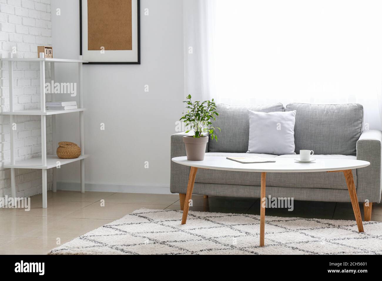 Stylish interior of living room with table and sofa Stock Photo Alamy