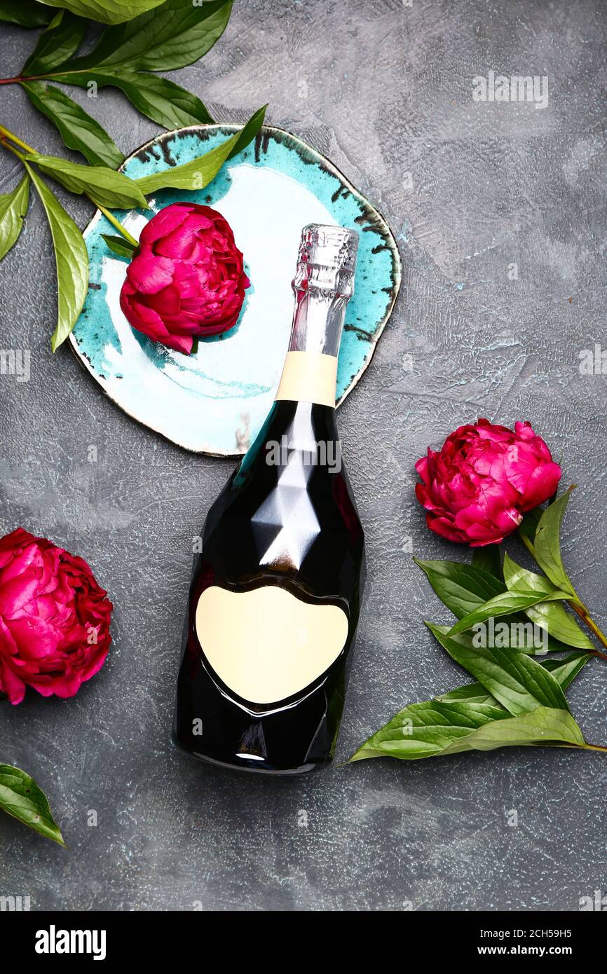 Composition with bottle of champagne and flowers on grey background Stock  Photo - Alamy