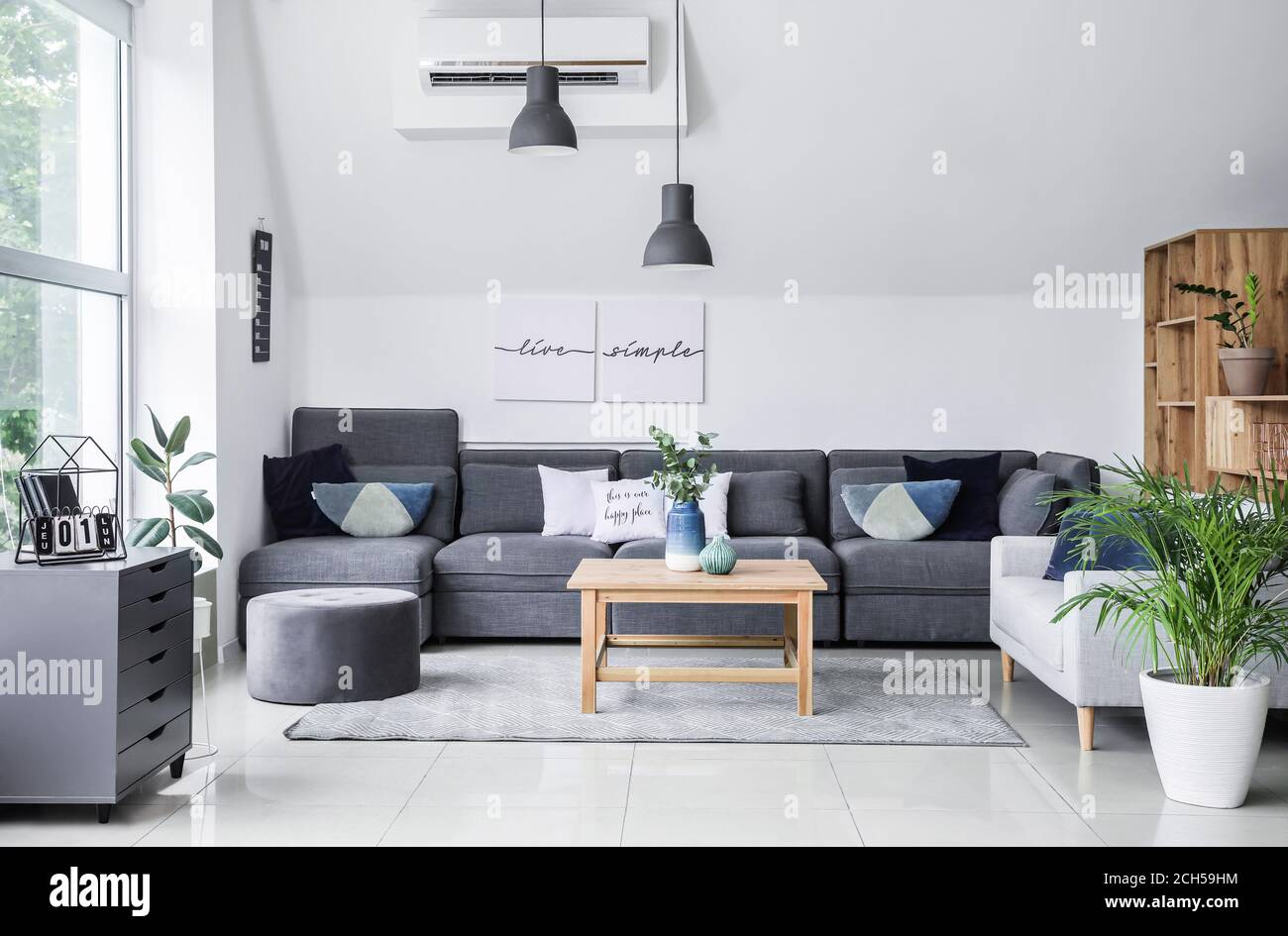 Stylish interior of living room with comfortable sofa and table Stock ...