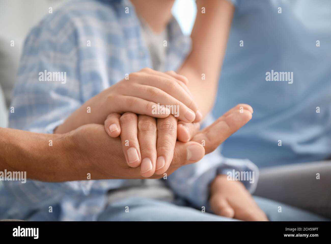 Family holding hands together at home, closeup Stock Photo - Alamy