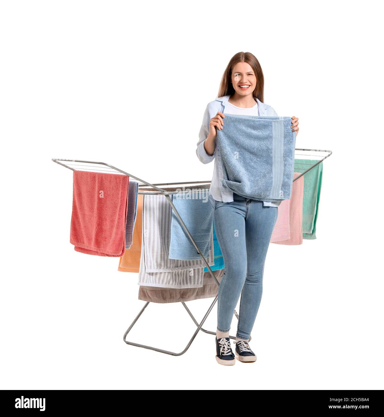 Woman with clean towels and clothes dryer on white background Stock