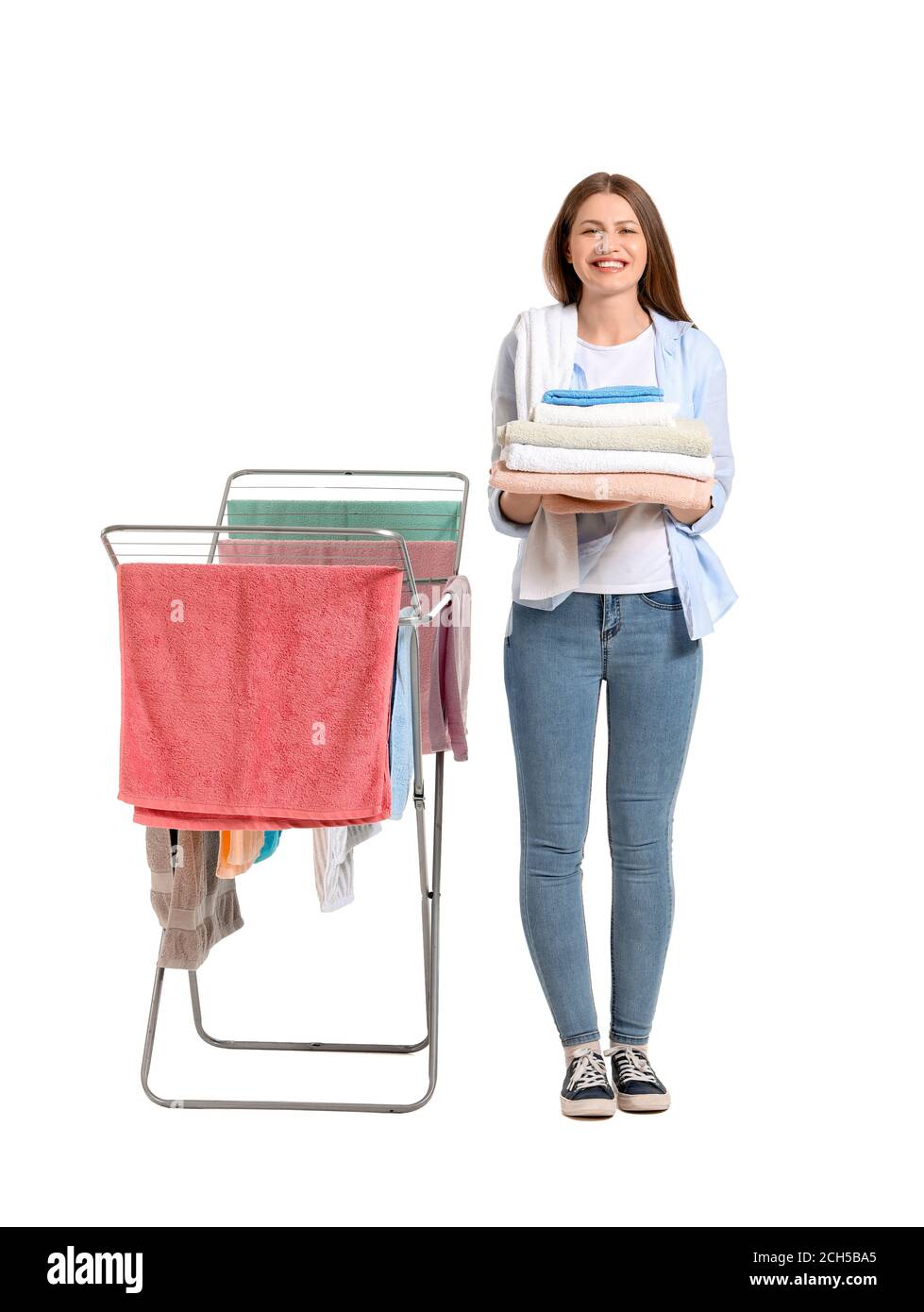 Woman with clean towels and clothes dryer on white background Stock