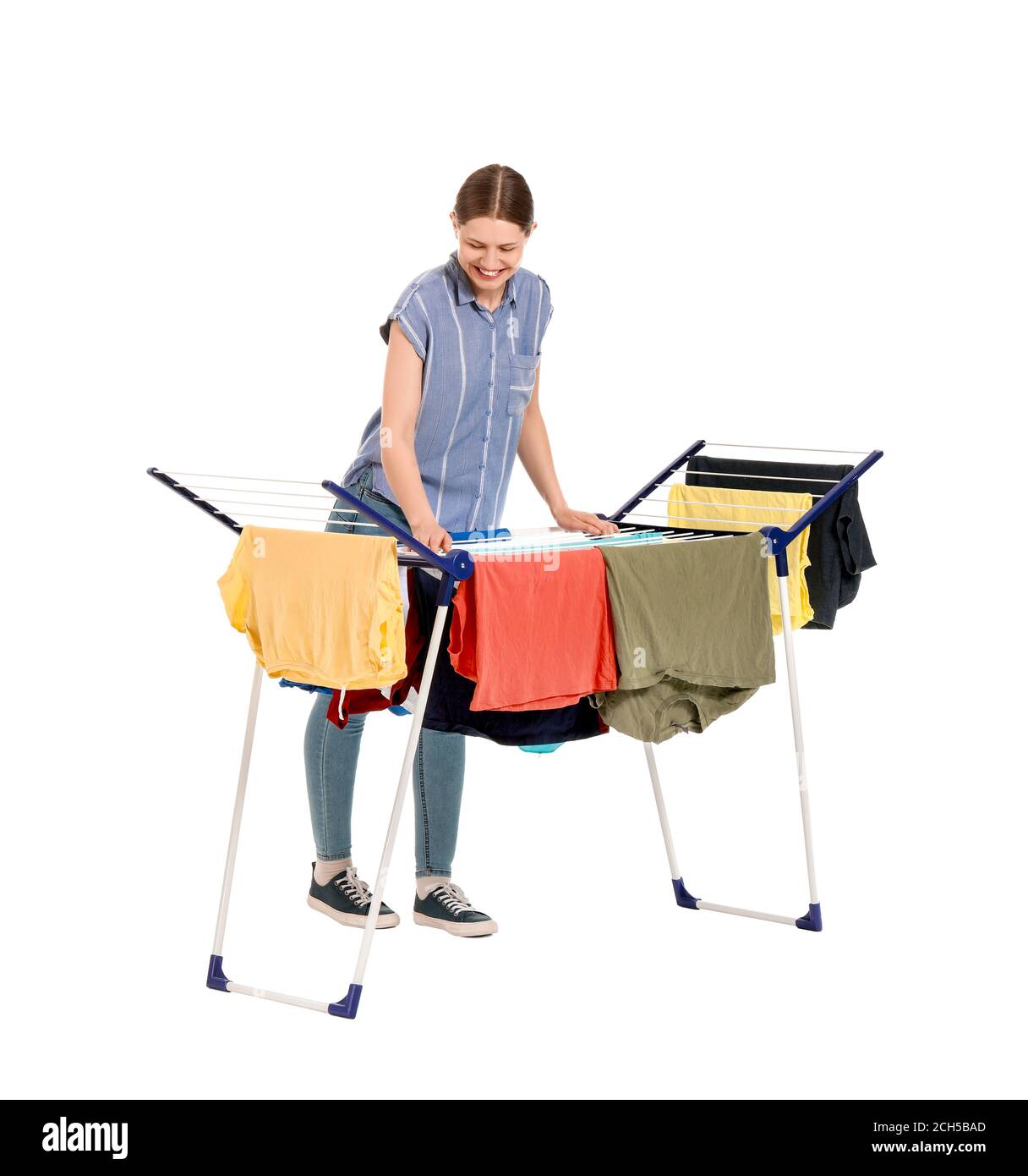 Woman hanging clean clothes on dryer against white background Stock