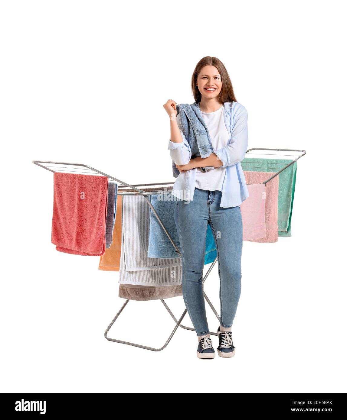 Woman with clean towels and clothes dryer on white background Stock