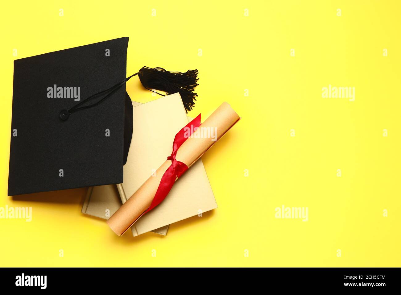 Graduation hat, books and diploma on color background Stock Photo - Alamy