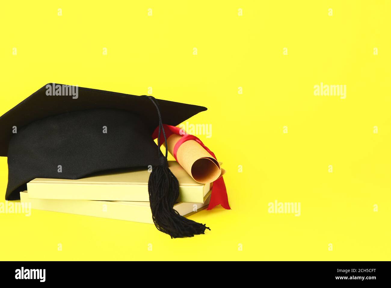 Graduation hat, books and diploma on color background Stock Photo - Alamy