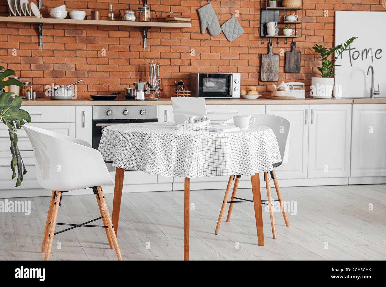 Interior of stylish modern kitchen with dining table Stock Photo - Alamy