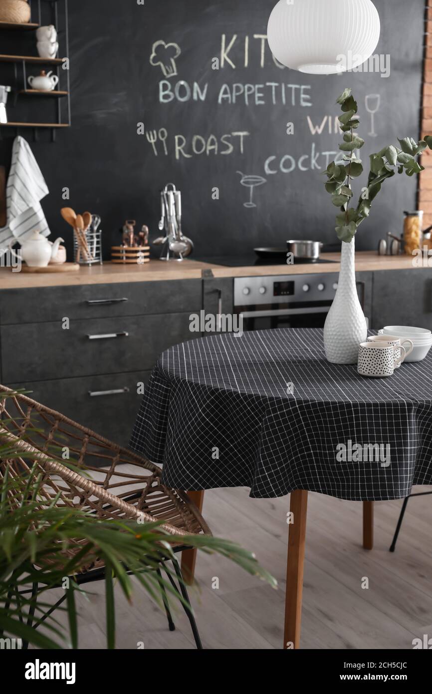 Interior of stylish modern kitchen with dining table Stock Photo - Alamy