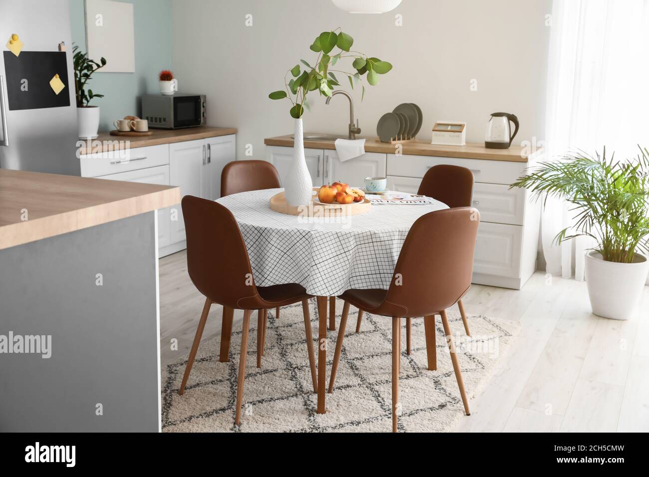 Interior of stylish modern kitchen with dining table Stock Photo - Alamy