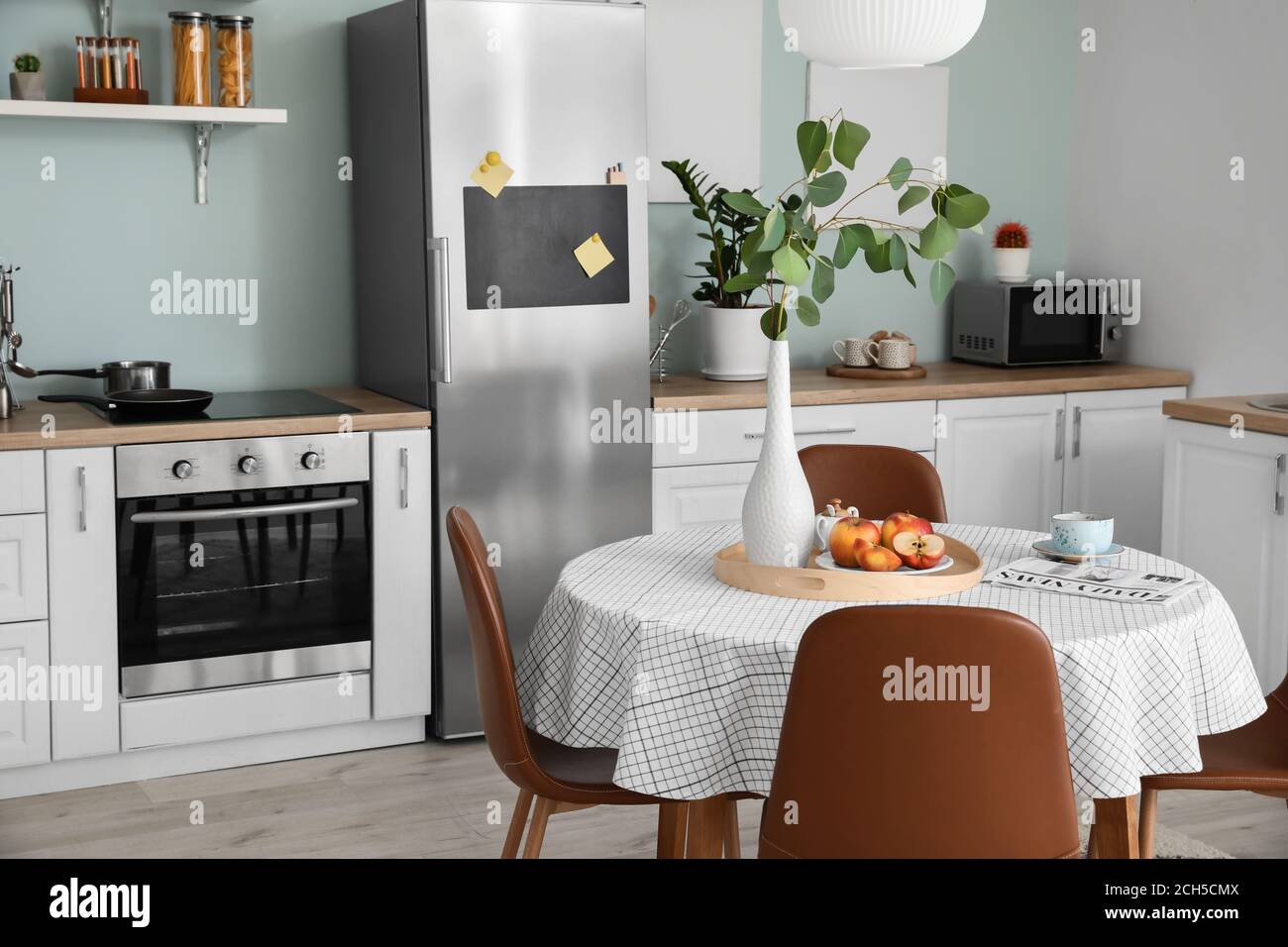 Interior of stylish modern kitchen with dining table Stock Photo - Alamy