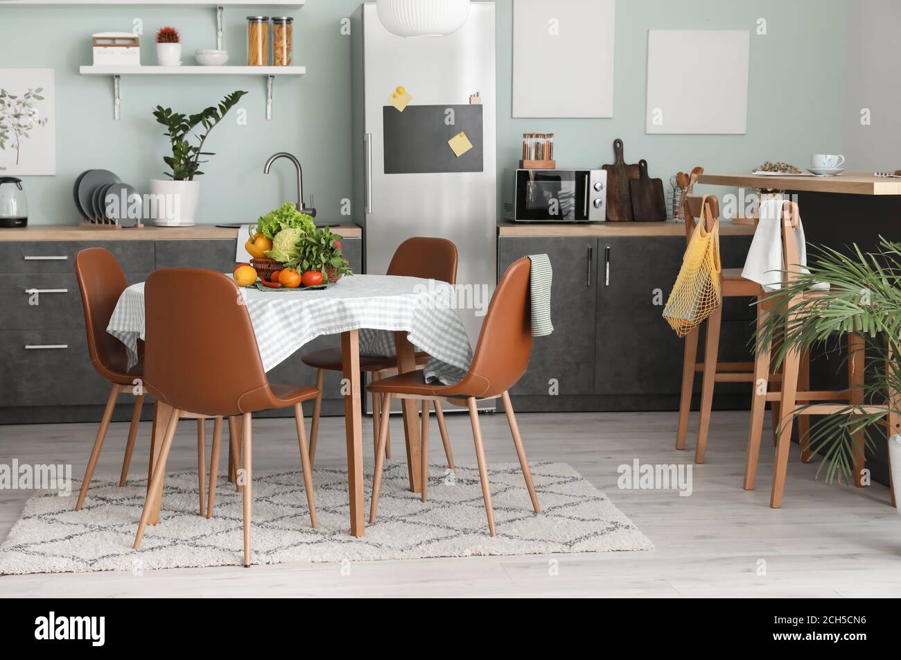 Interior of stylish modern kitchen with dining table Stock Photo - Alamy