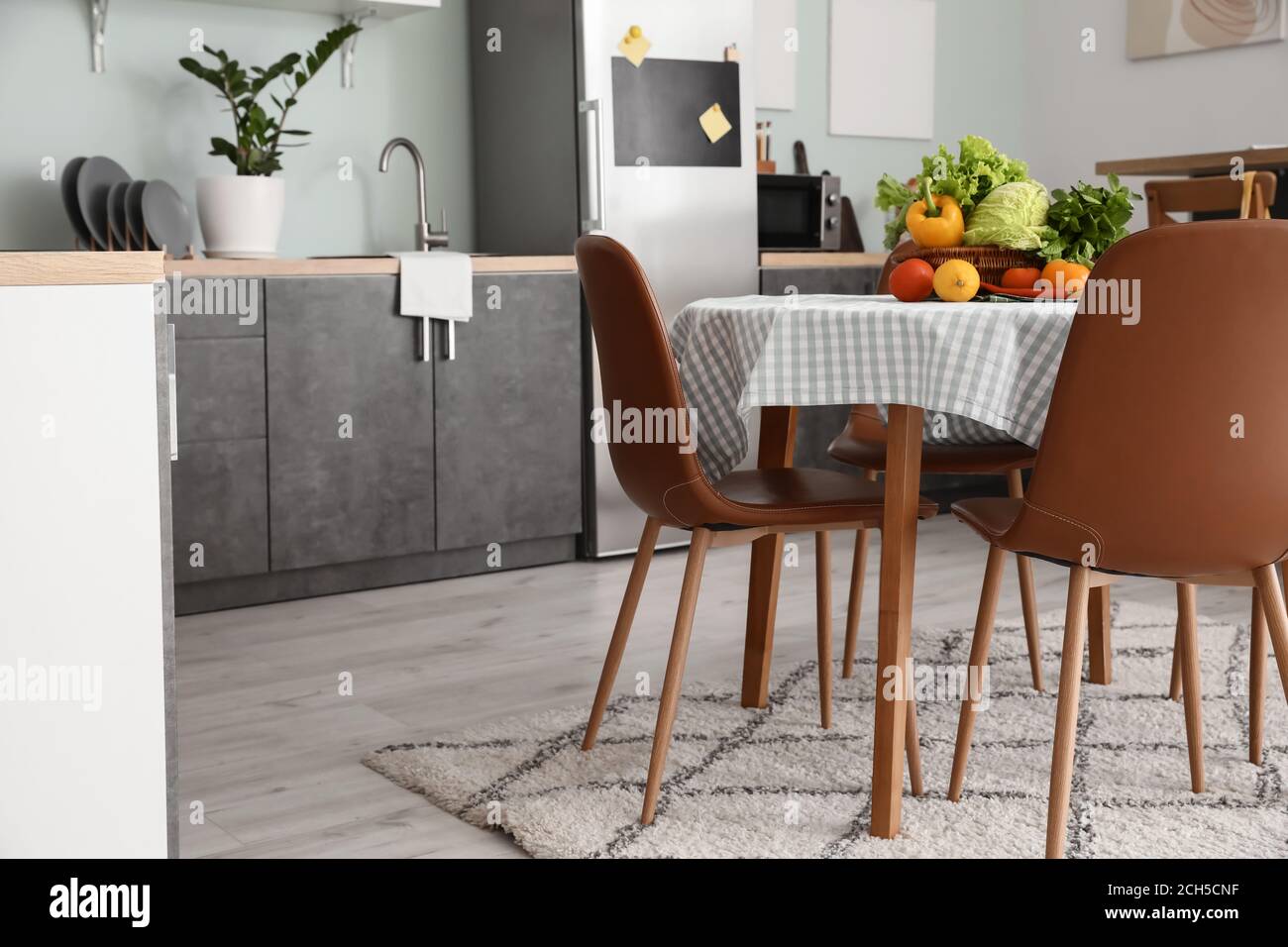 Interior of stylish modern kitchen with dining table Stock Photo - Alamy
