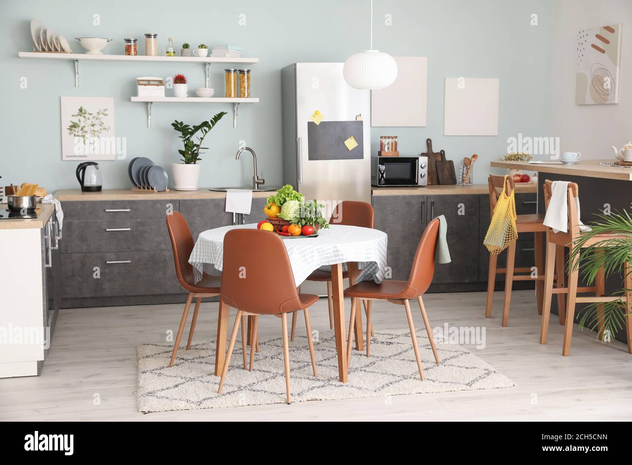 Interior of stylish modern kitchen with dining table Stock Photo - Alamy