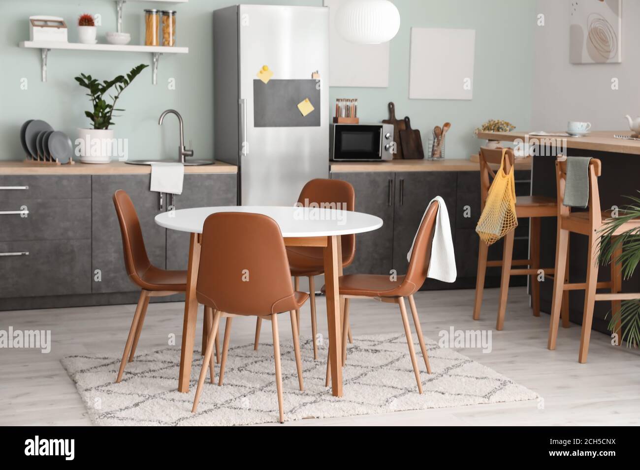 Interior of stylish modern kitchen with dining table Stock Photo - Alamy