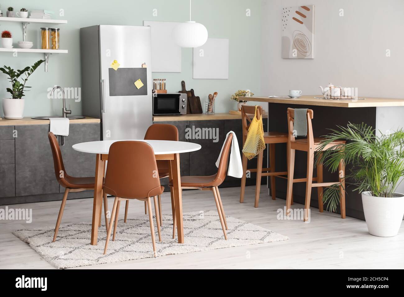 Interior of stylish modern kitchen with dining table Stock Photo - Alamy