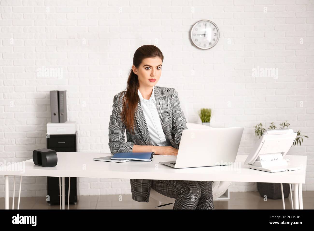 Beautiful young businesswoman working in office Stock Photo - Alamy