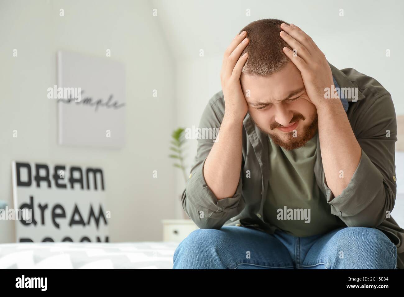 Man suffering from headache at home Stock Photo - Alamy