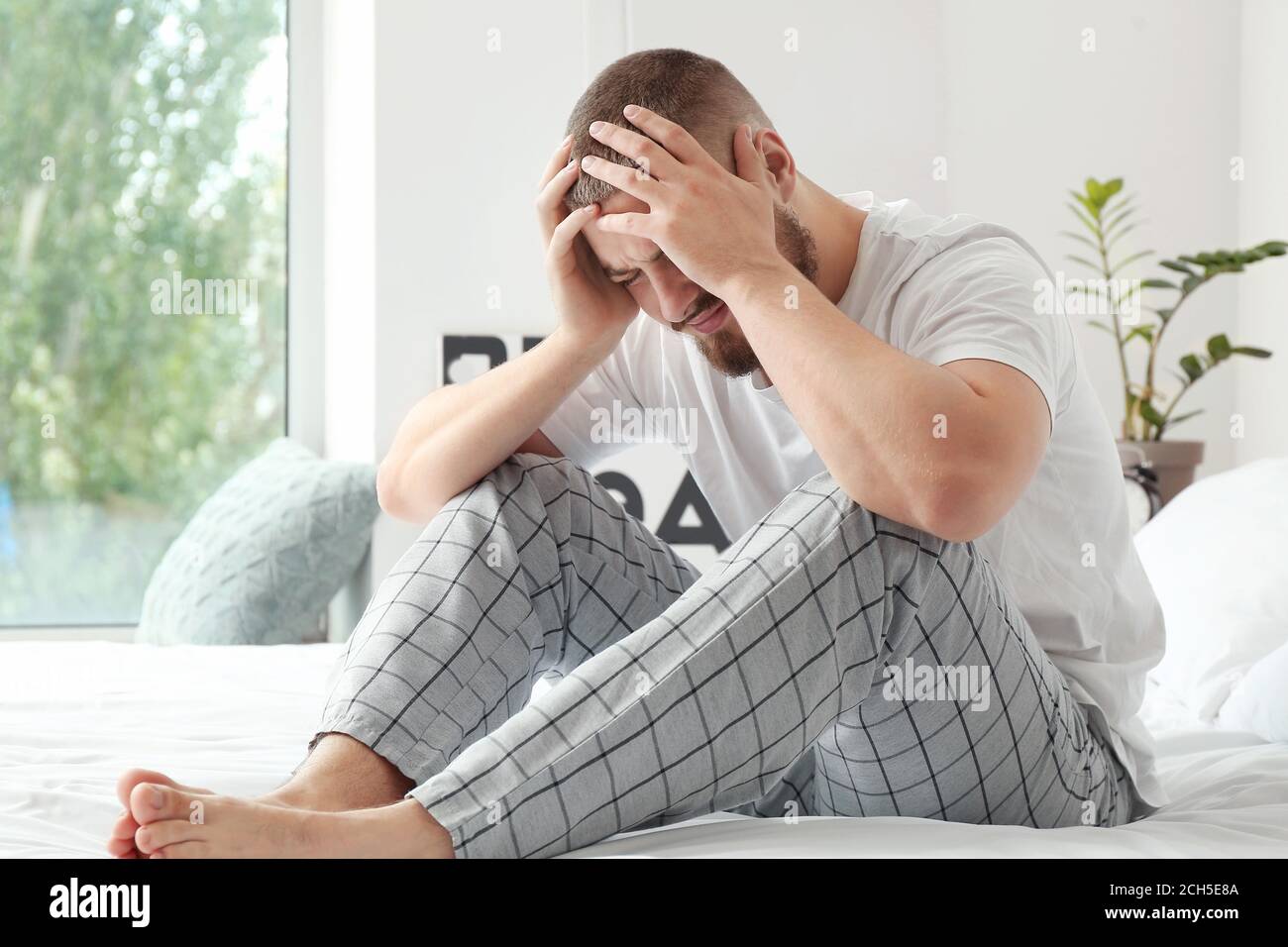 Man suffering from headache at home Stock Photo - Alamy