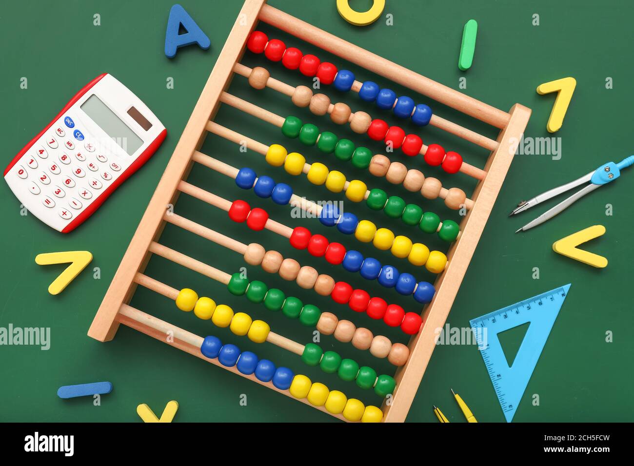 Abacus and stationery on color background Stock Photo