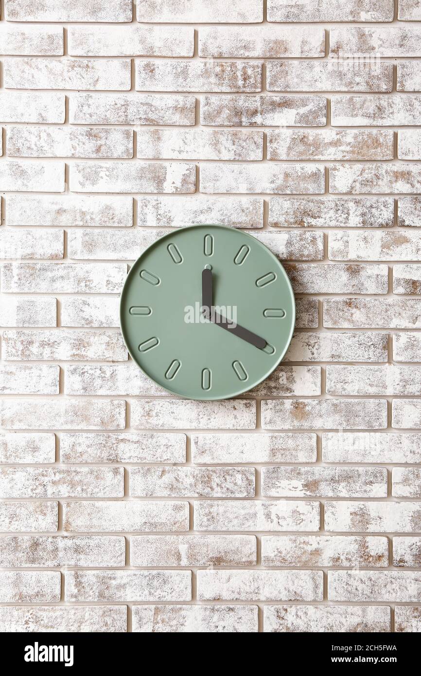 Simple clock on brick wall Stock Photo Alamy