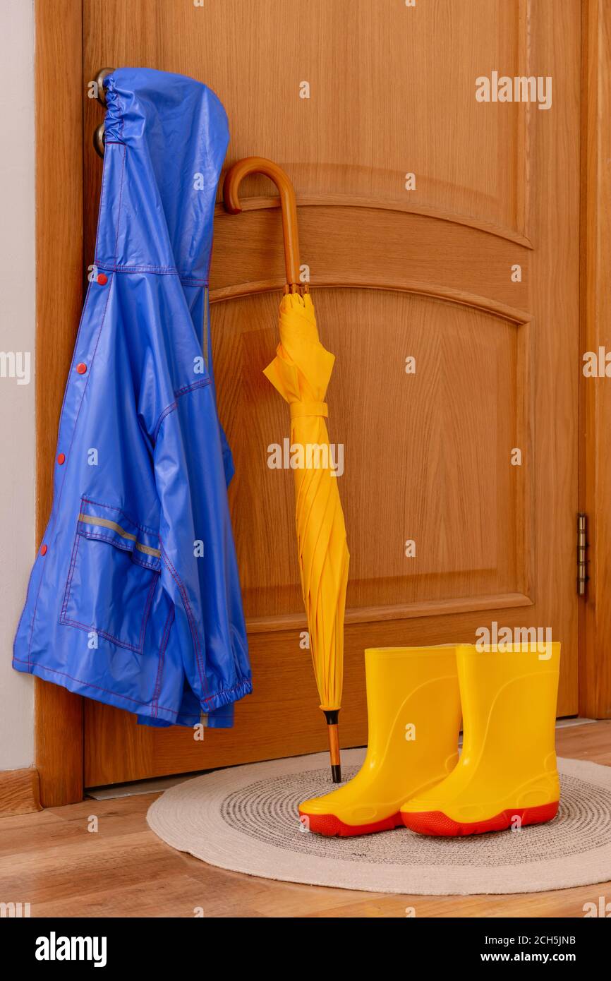 Rubber Boots Umbrella Mat Door Hallway Stock Photo by ©NewAfrica