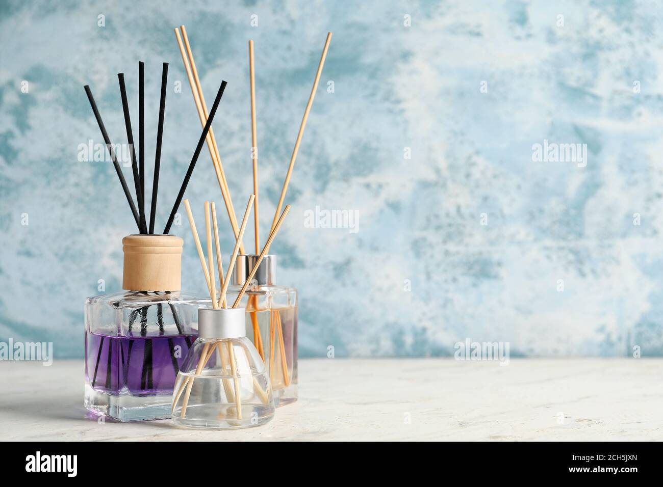 Different reed diffusers on table Stock Photo