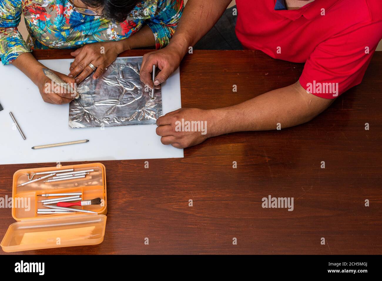 woman and man making a metal embossed frame with her own hands Stock ...