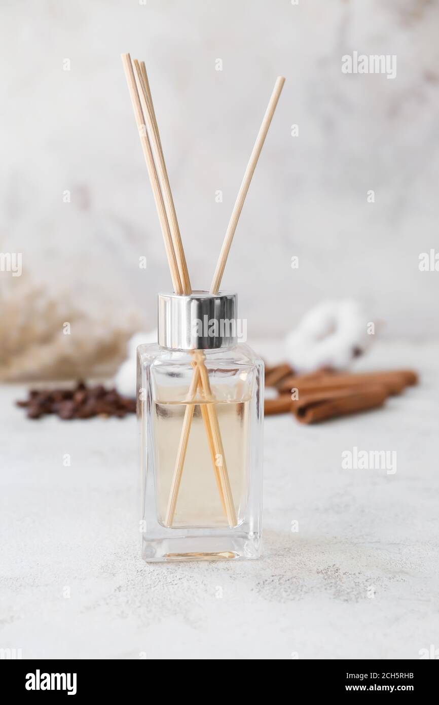 Reed diffuser, cotton, coffee beans and cinnamon on table Stock Photo