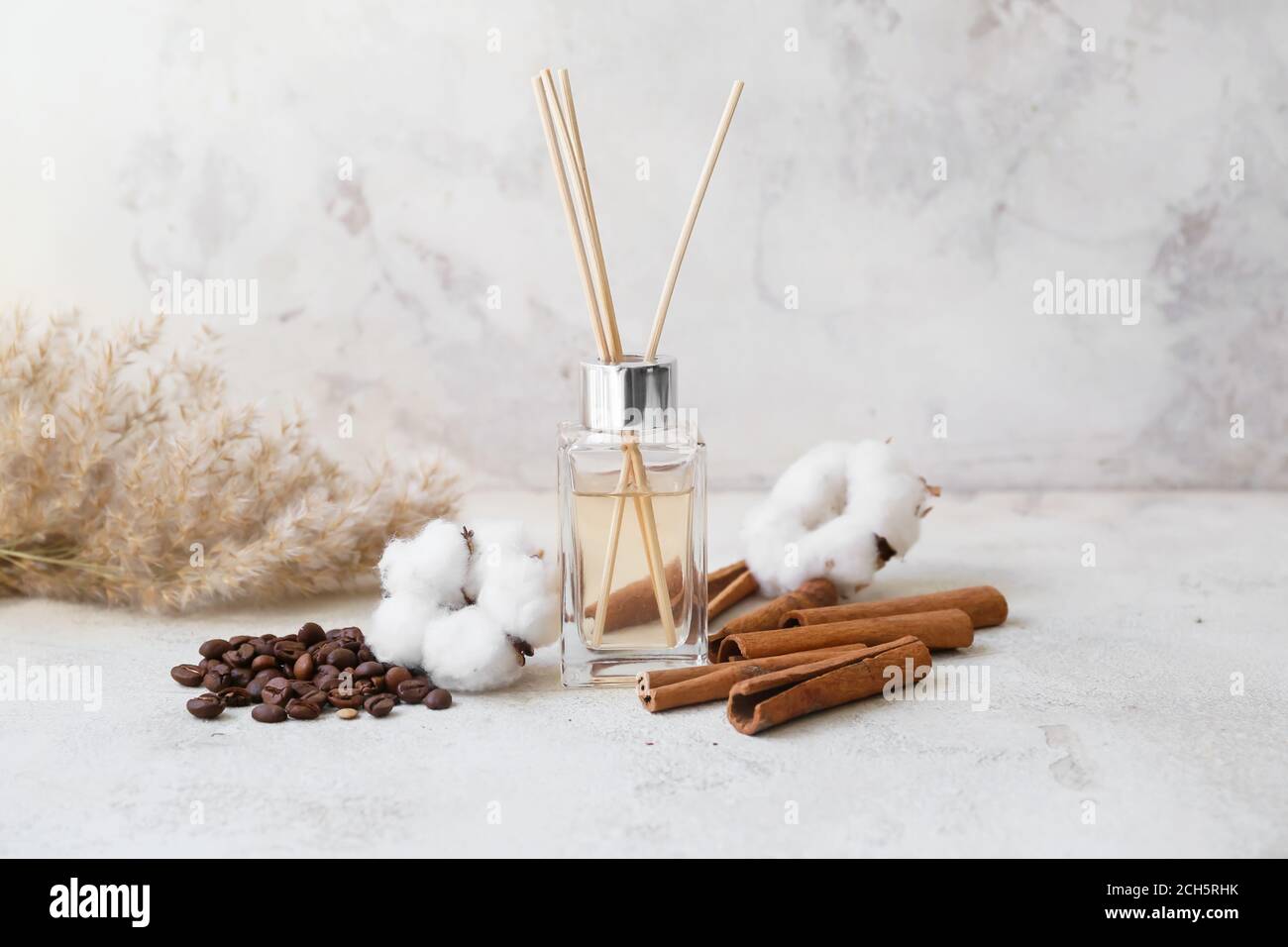 Reed diffuser, cotton, coffee beans and cinnamon on table Stock Photo