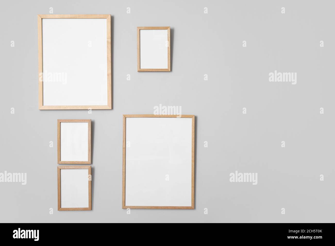 Blank photo frames hanging on wall Stock Photo - Alamy
