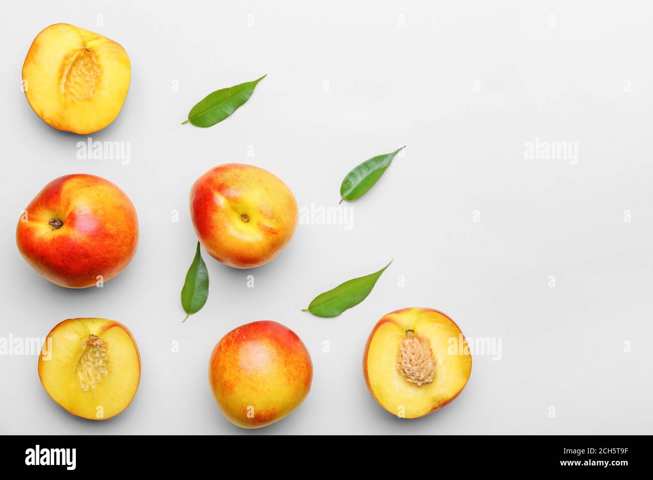 Sweet ripe nectarines on light background Stock Photo