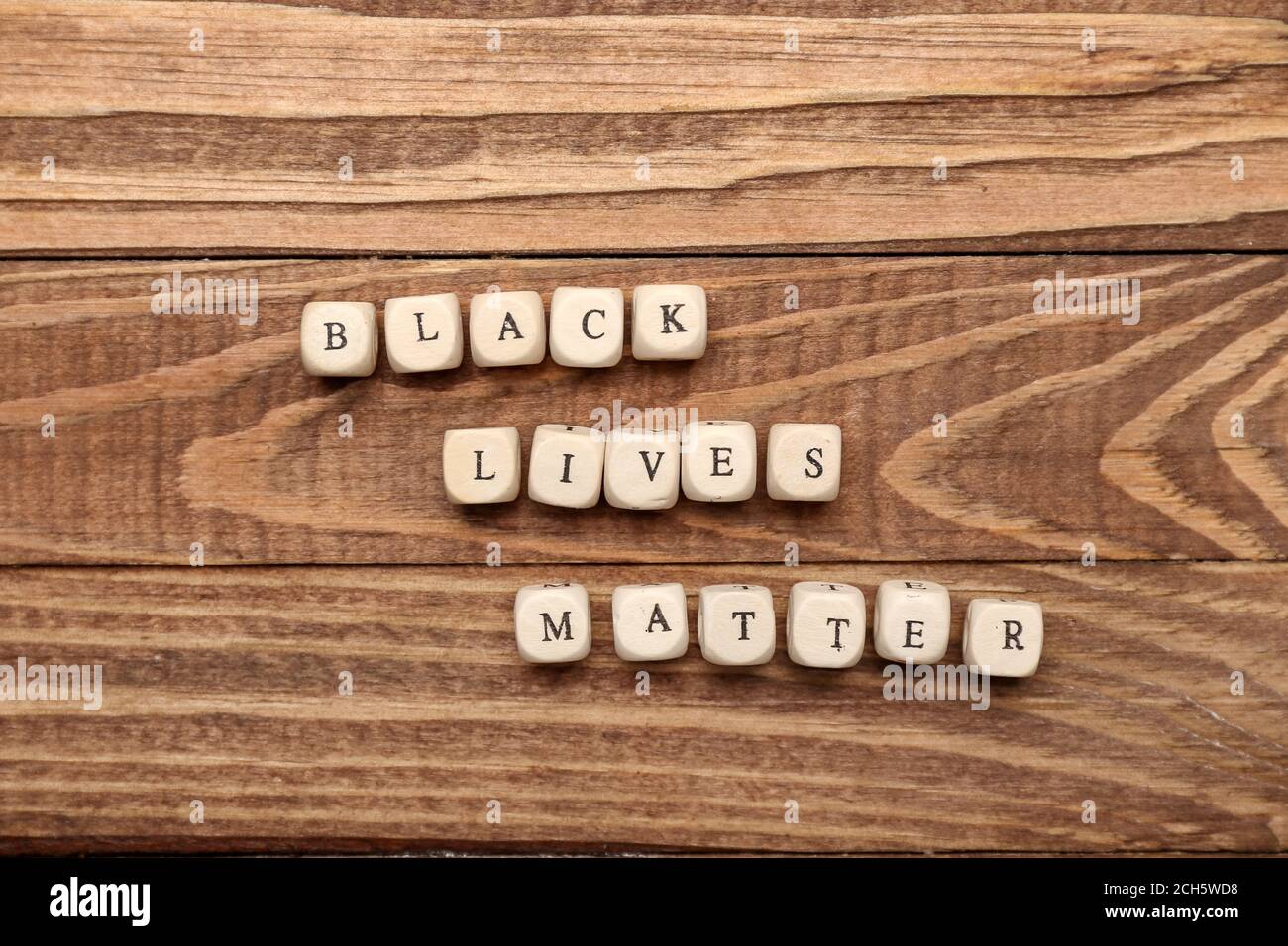 Cubes with text BLACK LIVES MATTER on wooden background Stock Photo