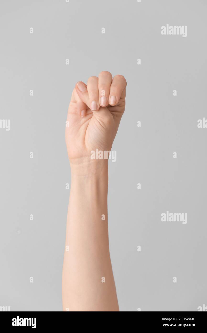 Hand showing letter M on grey background. Sign language alphabet Stock ...
