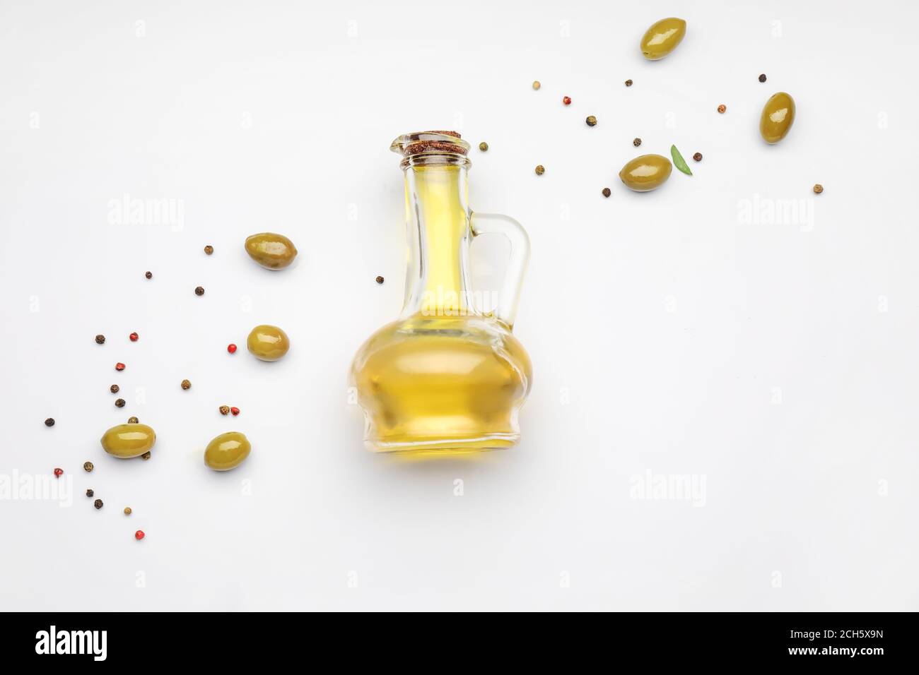 Jug of olive oil on white background Stock Photo Alamy