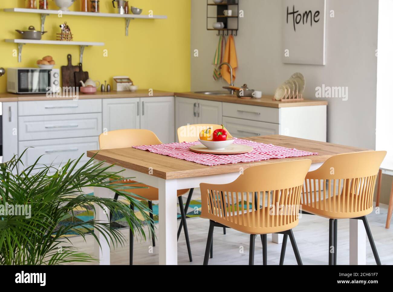 Dining table in interior of modern kitchen Stock Photo - Alamy