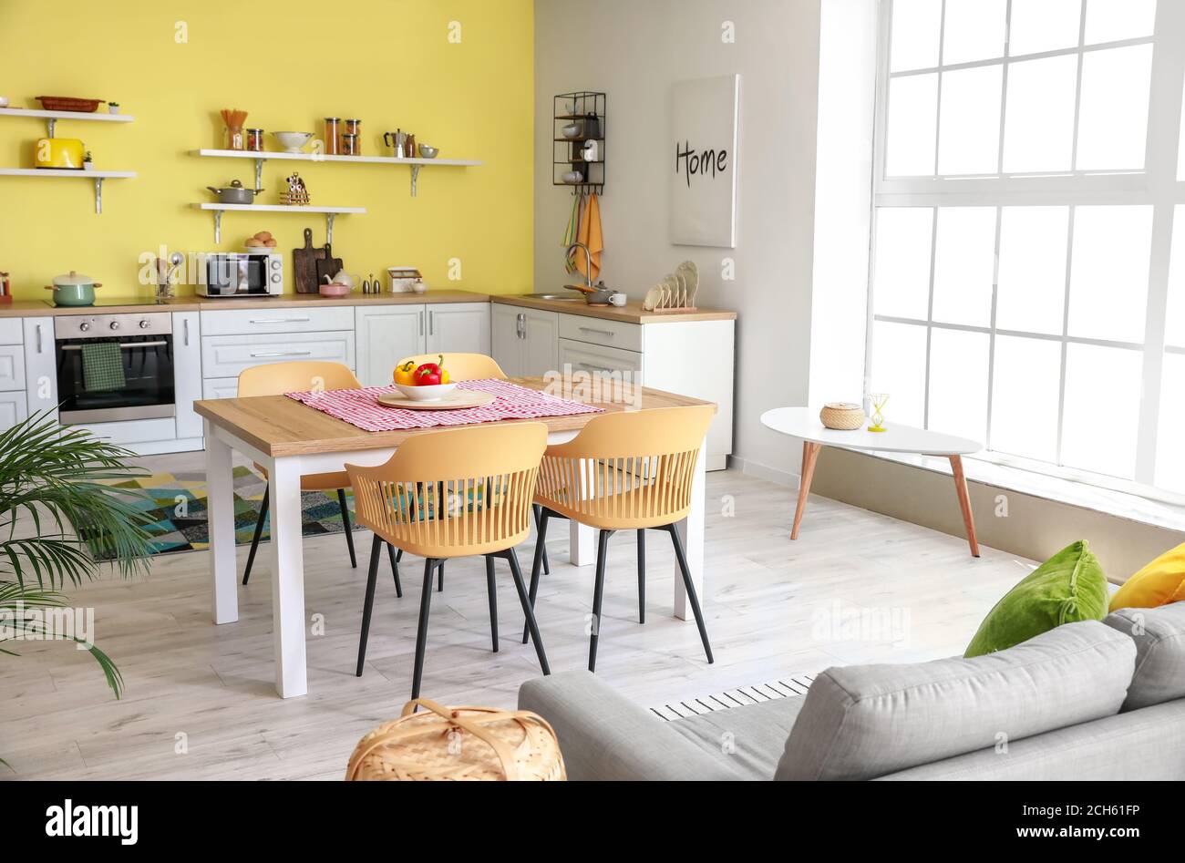 Interior of stylish modern kitchen with dining table Stock Photo - Alamy