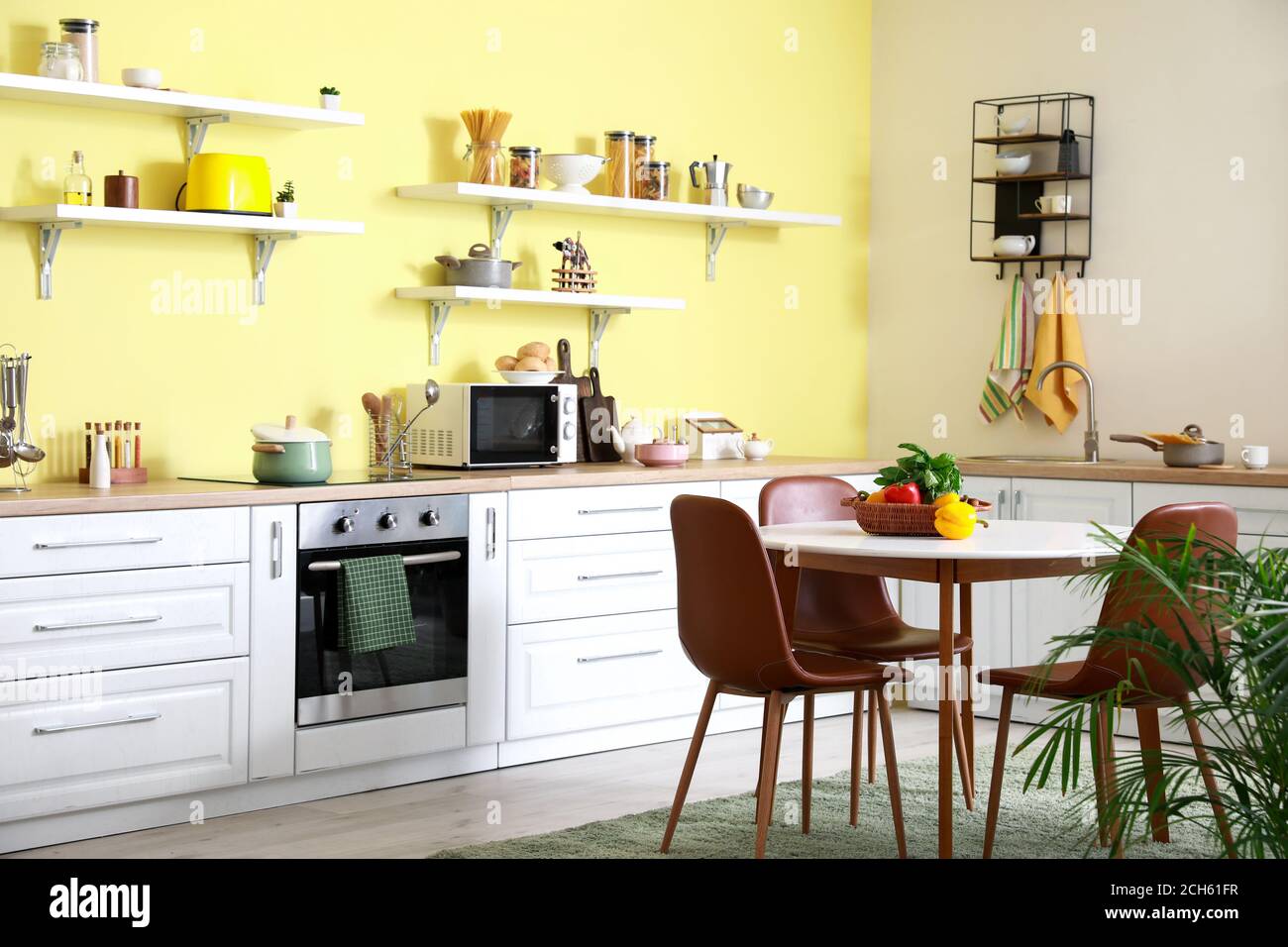 Interior of stylish modern kitchen with dining table Stock Photo - Alamy