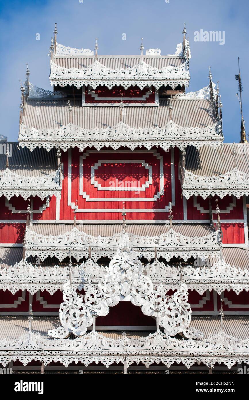 Picturesque carved silver tin tiles, roof and window awnings of ancient buddhist temple. Wat Phrathat Doi Kong Mu, Mae Hong Son, Thailand. Stock Photo