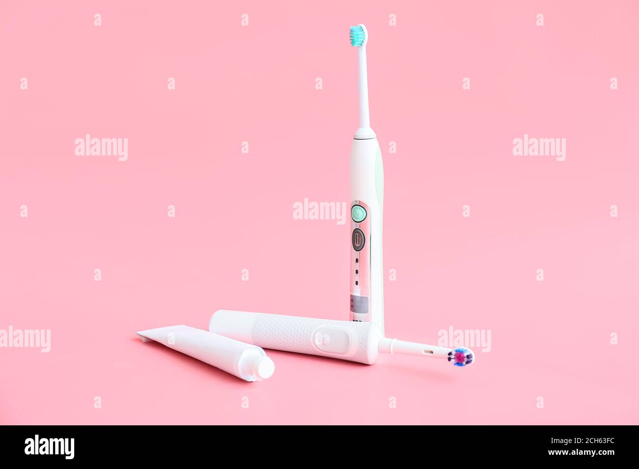 Electric tooth brushes and paste on color background Stock Photo - Alamy
