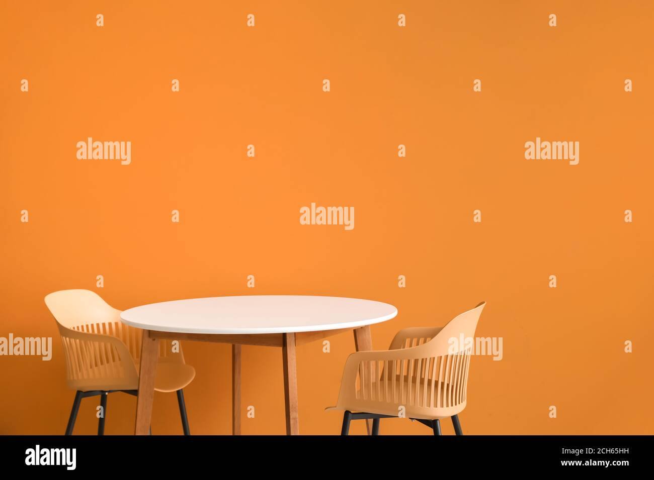 Dining table near color wall Stock Photo Alamy