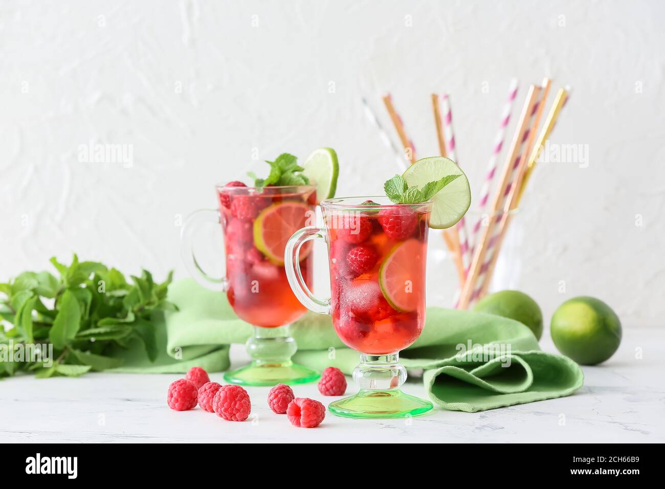 Cups of cold raspberry tea on table Stock Photo - Alamy